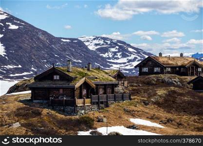 old traditional norwegian wooden house in Tyin and mountains in the background, Norwayn