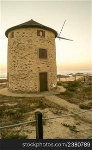 Old traditional wind-mills in sand-hills of Apulia Portugal
