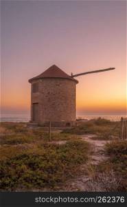 Old traditional wind-mills in sand-hills of Apulia Portugal