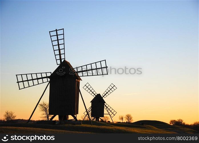 Old traditional windmills in late evening sun at the swedish island Oland