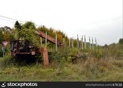 Old trailer with wood grip under the vegetation