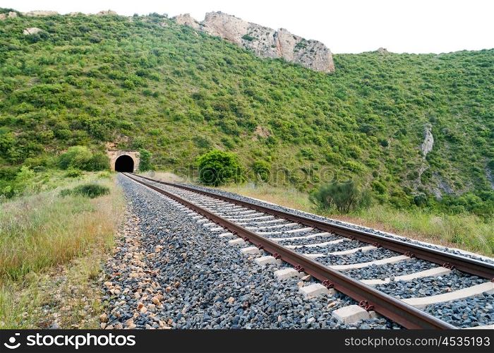 Old train tunnel with railway in a mountain
