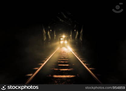 Old trains run through old tunnels at night.