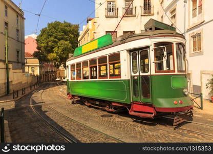 Old tram on narrow european street in sunny days. Tram on the street