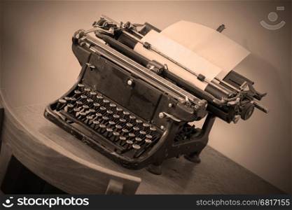 Old typewriter on a small wooden table