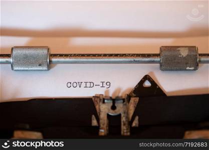 Old typewriter with the word COVID 19