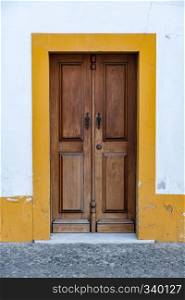 Old typical brown painted wood Portuguese door.