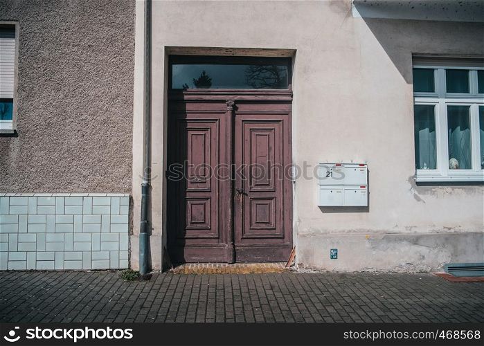 Old typical european facade with old styled wooden doors