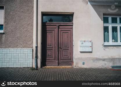 Old typical european facade with old styled wooden doors