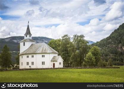 old typical norway wooden stave church in bygdal in norway near valle with the mountains as background. ardal church in bygland norway near Valle
