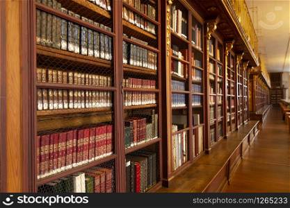 Old university shelves with lots of antique books