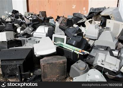 Old used and obsolete electronic equipment before a building. Old used and obsolete electronic equipment