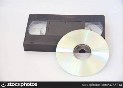old videotape and compact disc on white background