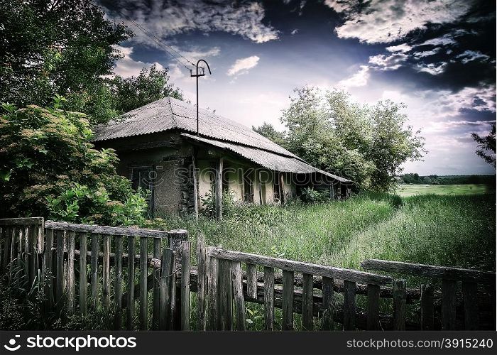 Old village house under a dramatic cloudy sky