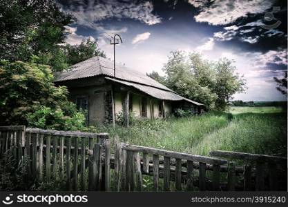 Old village house under a dramatic cloudy sky