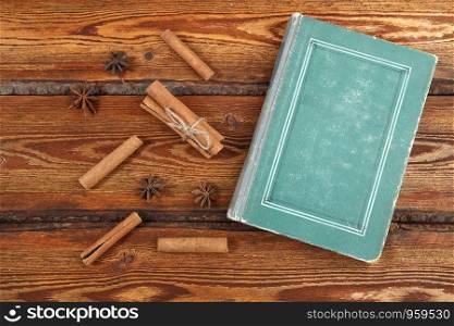 old vintage book on dark wooden background . top view. flat lay