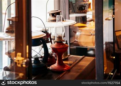 Old vintage fueled lanterns or kerosene lantern antique on wood table with warm tone light