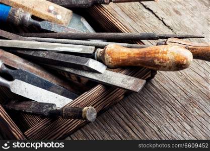 Old vintage hand tools on wooden background. Retro carpenter tool
