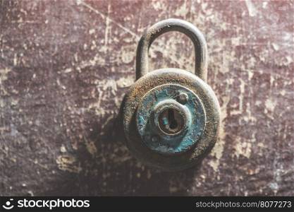 Old vintage padlock on wooden background