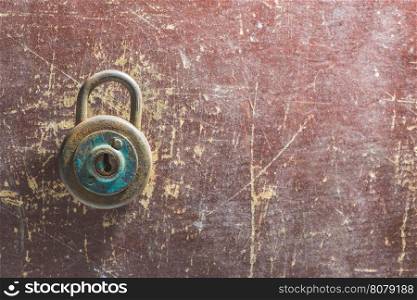 Old vintage padlock on wooden background