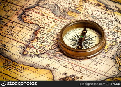 Old vintage retro compass on ancient map