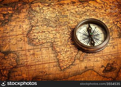 Old vintage retro compass on ancient map