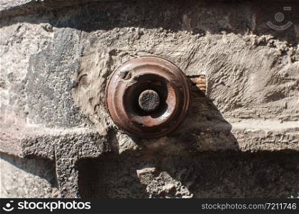 Old vintage retro weathered electric doorbell on grunge house facade