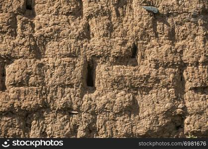 Old vintage rural house clay brick wall closeup as textured background