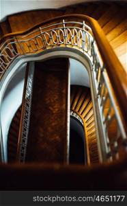 old vintage semicircular staircase with wooden stairs