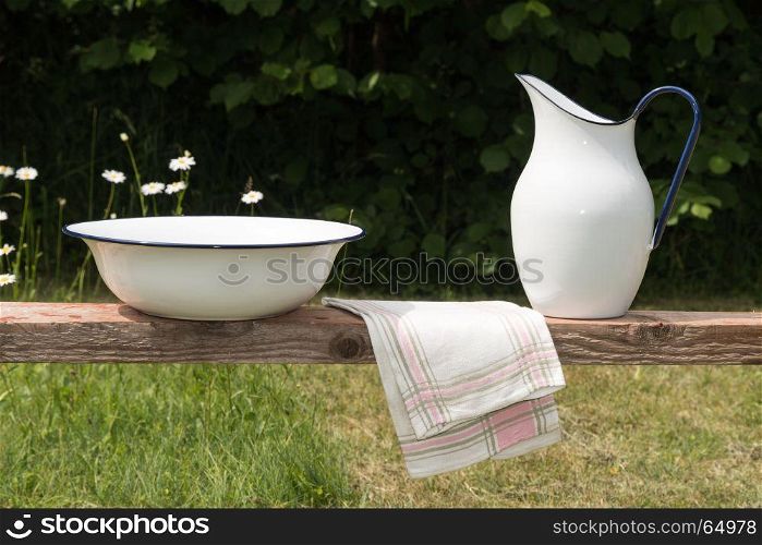 Old vintage wash equipment in a green garden with white flowers