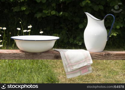 Old vintage wash equipment in a green garden with white flowers