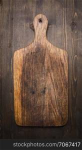 old vintage wooden cutting board on wooden rustic background top view close up