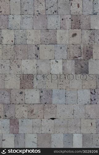 Old wall of decorative pink tuff tiles. Wall of pink tuff tiles