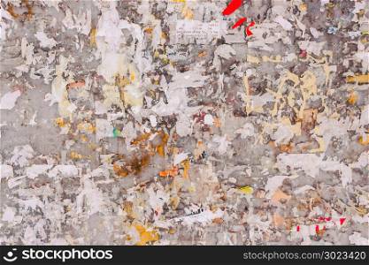 Old wall with remains of paper ads as background