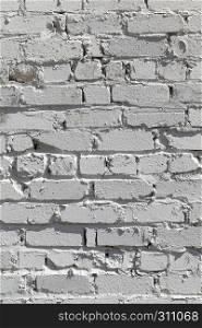 old walls made of bricks painted with white paint or lime. Brick painted wall.