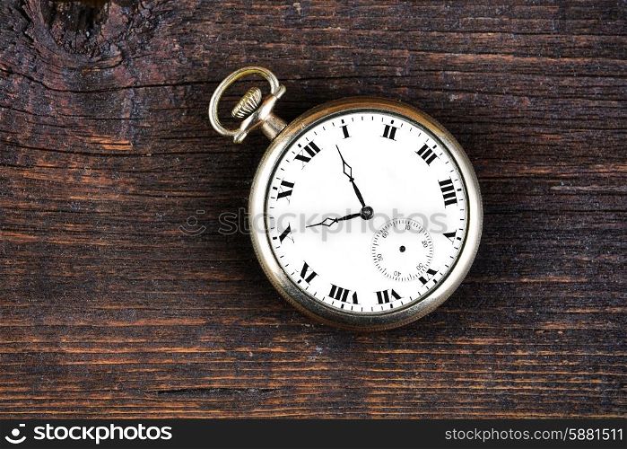 old watch on wooden background