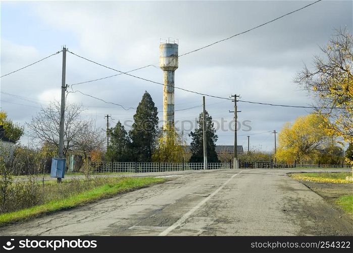 Old water tower in the village. Autumn landscape. Old water tower in the village. Autumn landscape.