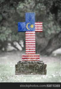Old weathered gravestone in the cemetery - Malaysia