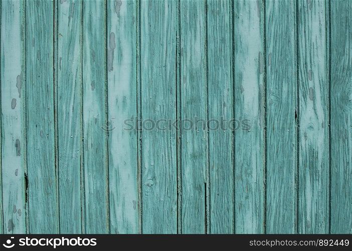 Old weathered grunge green painted wooden boards wall closeup as background