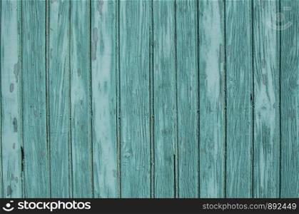 Old weathered grunge green painted wooden boards wall closeup as background