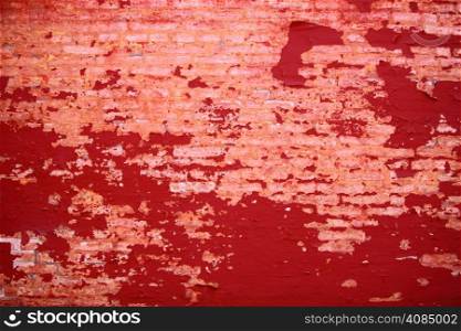 Old weathered painted red brick wall fragment grunge background