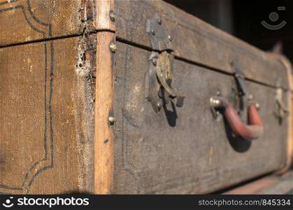 Old weathered retro vintage grunge suitcase handle and metal latch lock closeup