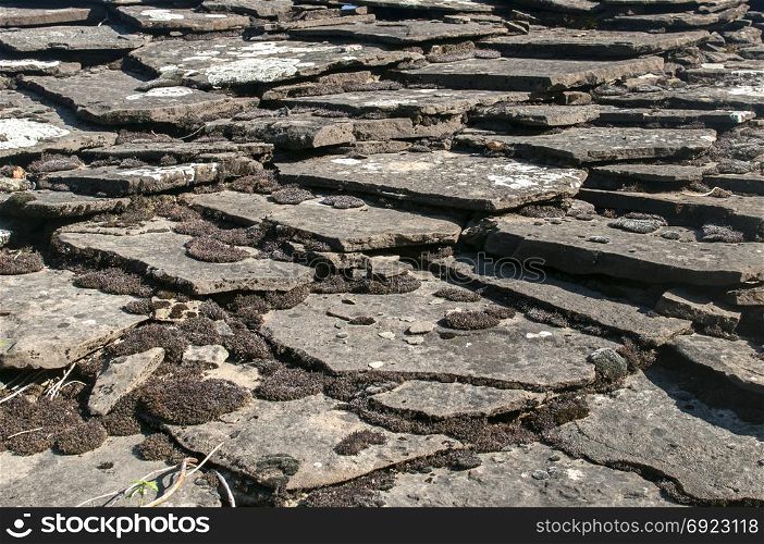 Old weathered rural roof stone slabs closeup as background