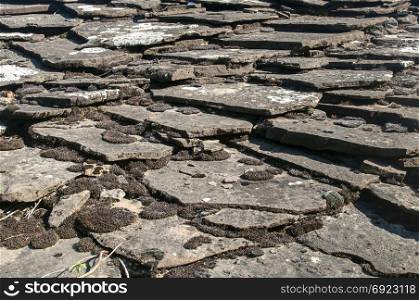 Old weathered rural roof stone slabs closeup as background
