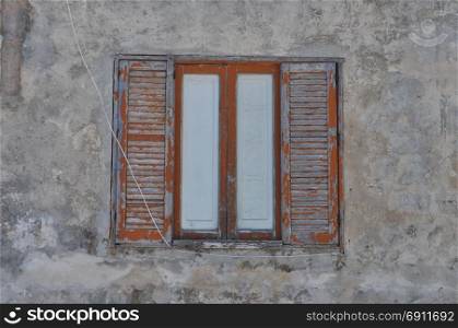 old weathered window. an old window in an ancient weathered wall
