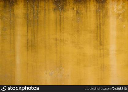 Old weathered yellow painted stucco wall texture