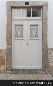 Old white wooden door with glass windows