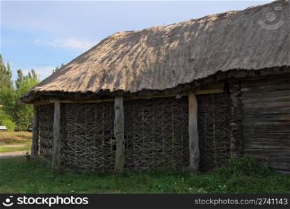 old wicker shed with thatch roof on historical country homestead