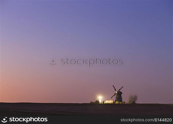Old windmill in a starry spring night