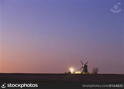 Old windmill in a starry spring night